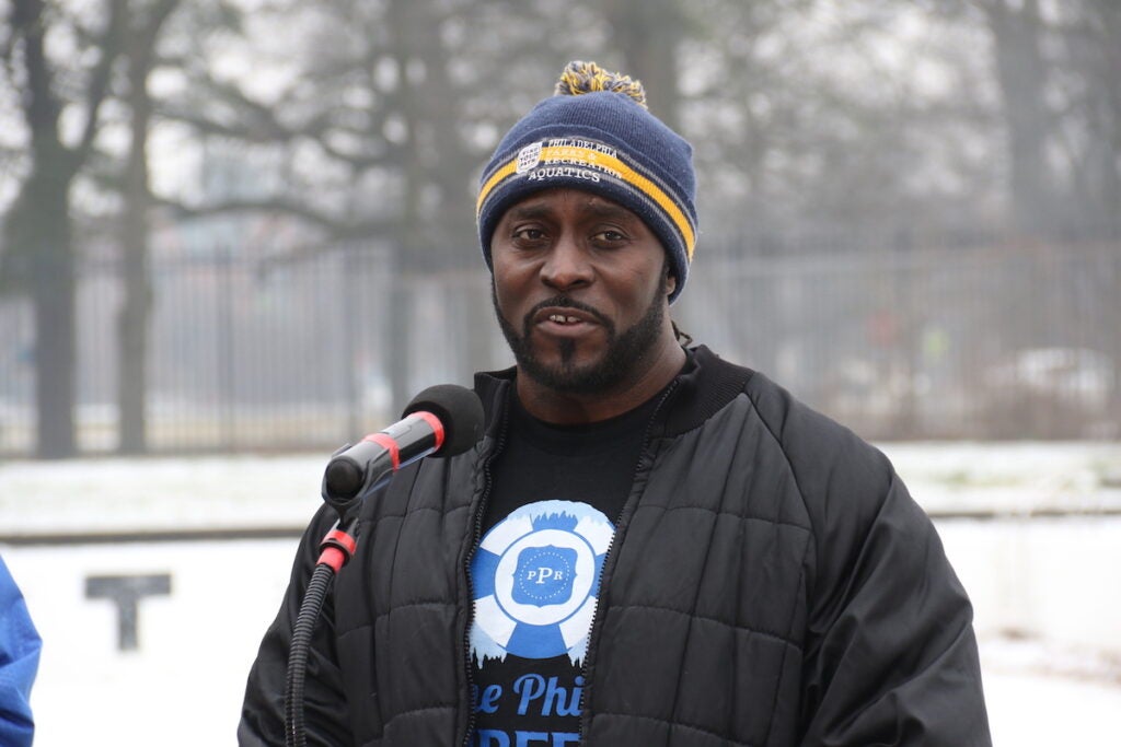 Water Safety Instructor Will Coleman speaks into a microphone