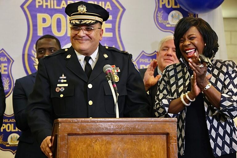 Cherelle Parker cheering as she introduces Pedro Rosario at a podium.