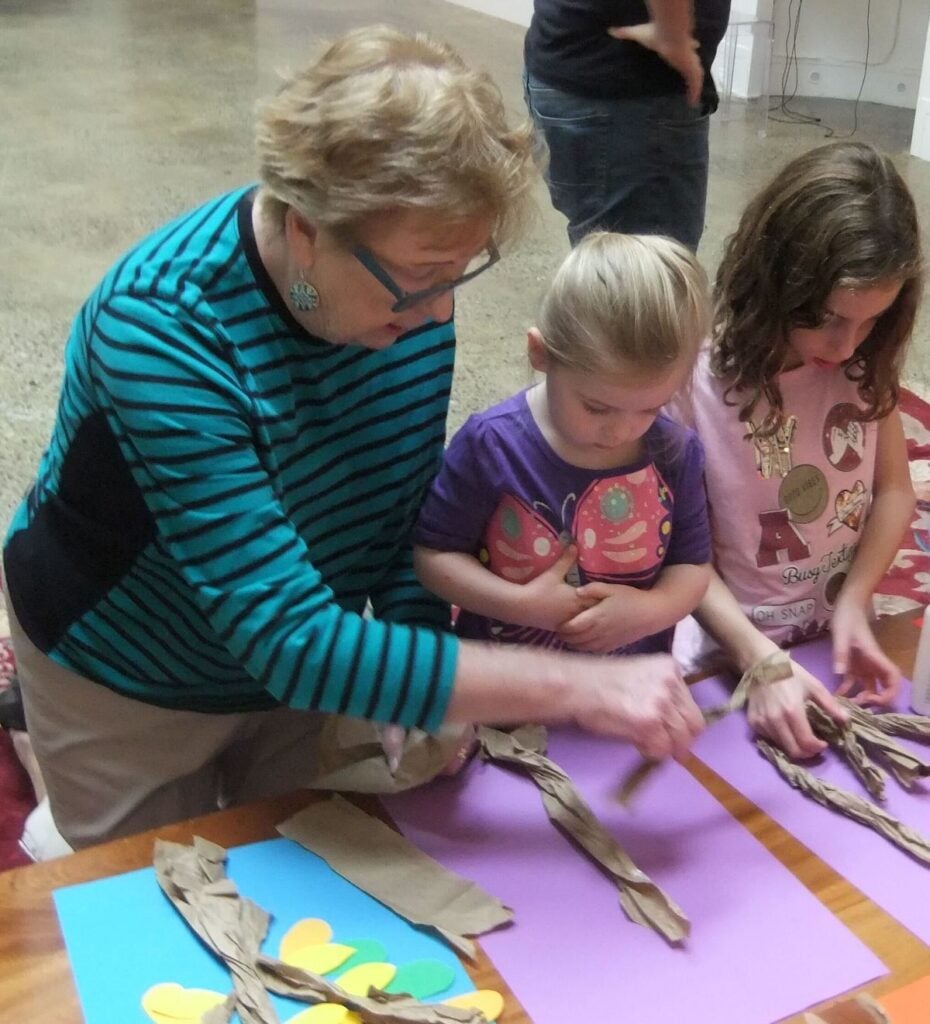 Kids get help from parents for their artworks