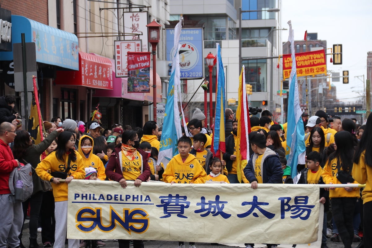 The Philadelphia Suns led the way for Sunday's Lion Dance through Chinatown with thousands gathering in the streets. (Cory Sharber/WHYY)