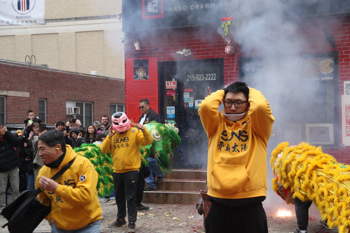 It was every man (and lion) for themselves during the Lunar New Year Parade in Chinatown on Feb. 11, 2024. (Cory Sharber/WHYY)