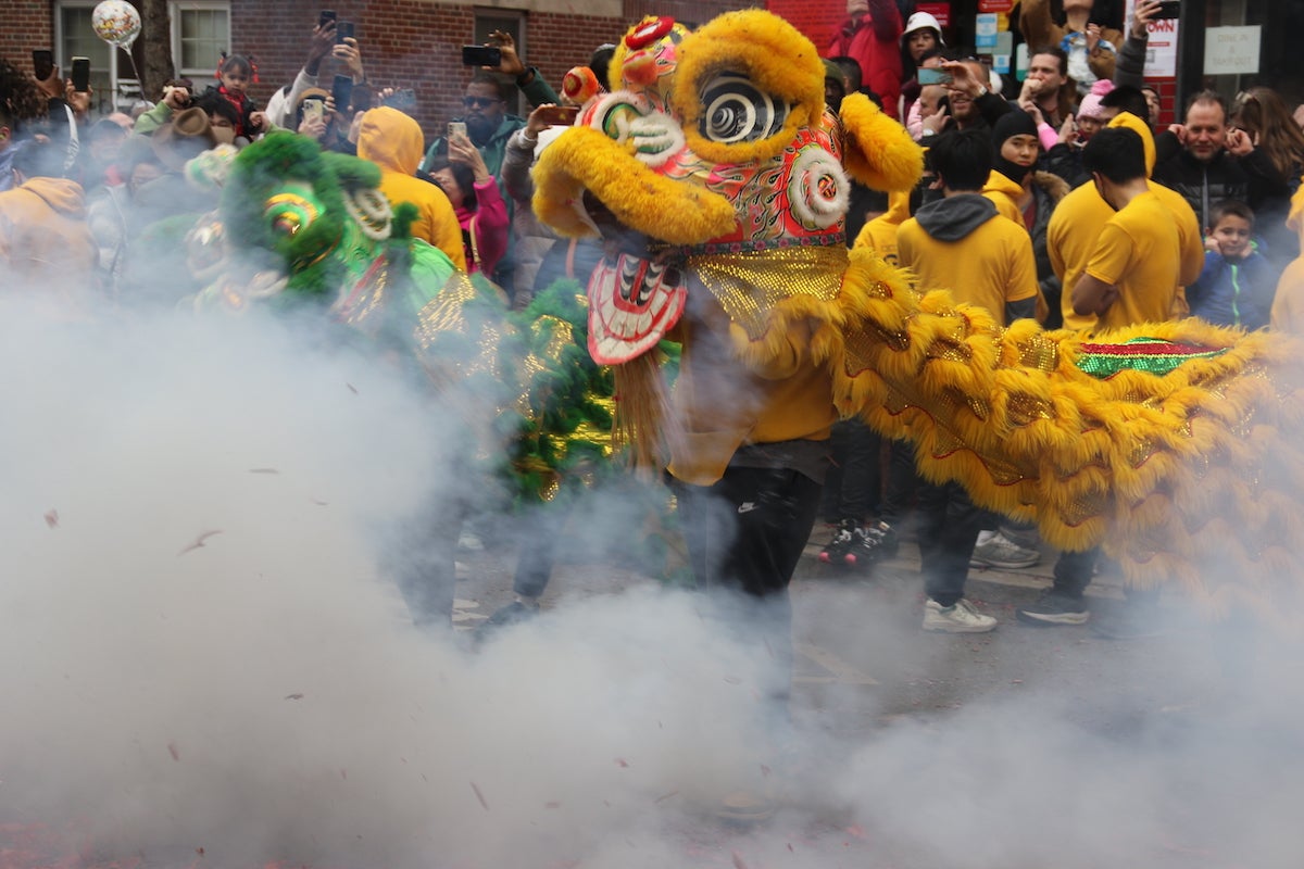 Chinatown was cloaked in the lion's breath during the Lunar New Year Parade on Feb. 11, 2024, celebrating the Year of the Dragon. (Cory Sharber/WHYY)