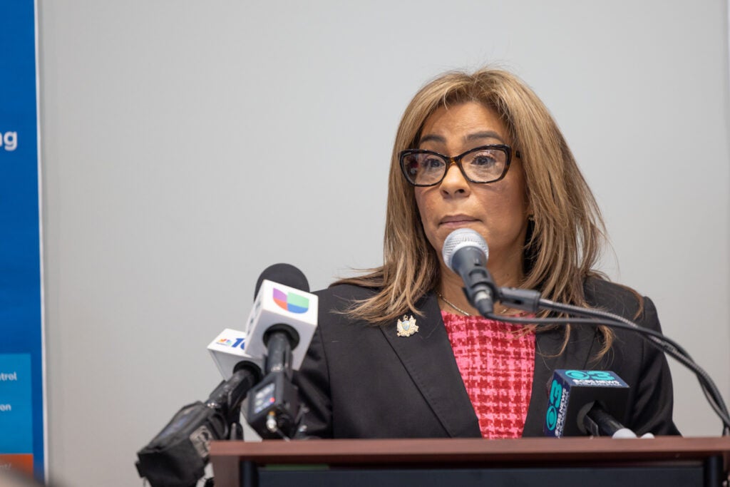 Quetcy Lozada speaking at a podium