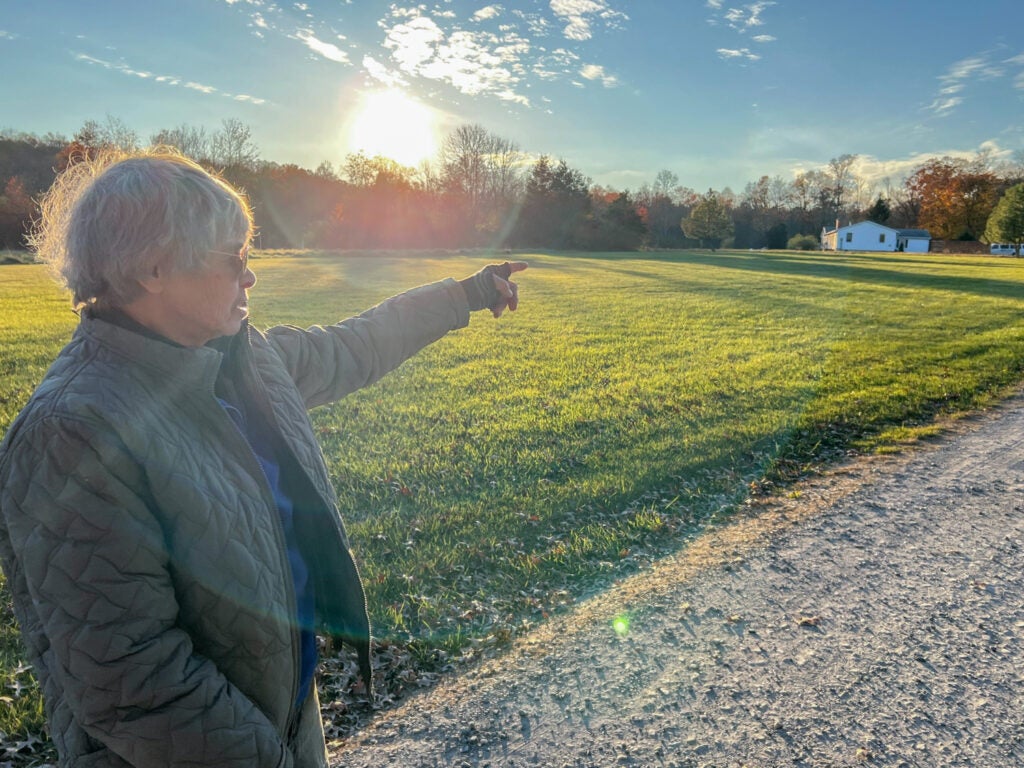 Judy Popivchak stands on a farm next to Haycock Camping Ministries