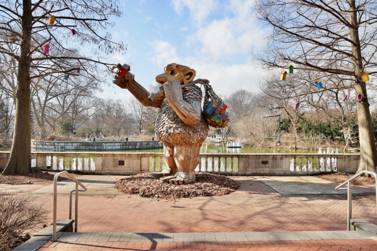 The troll Ibbi Pip is surrounded by colorful birdhouses at her location outside the Philadelphia Zoo's avian center.