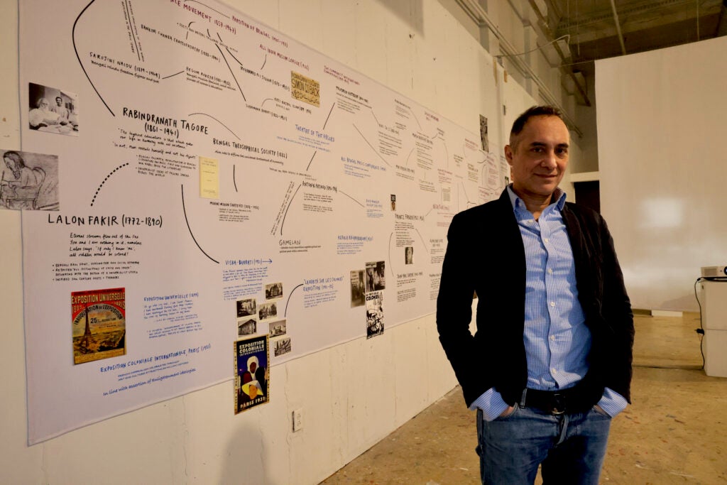 Curator Vali Mahlouji stands in front of an art display related to the banned Shiraz Festival of Arts at the Arts Initiative in Philadelphia.