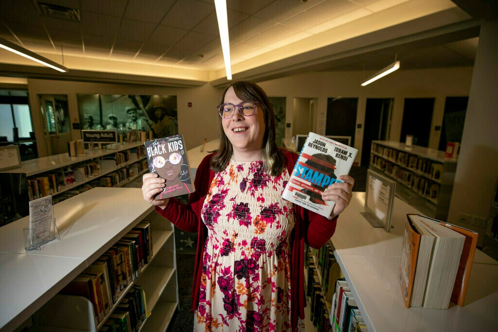 Blair-Caldwell African American Research Library teen librarian Juno Kling holds some of her favorite books. 