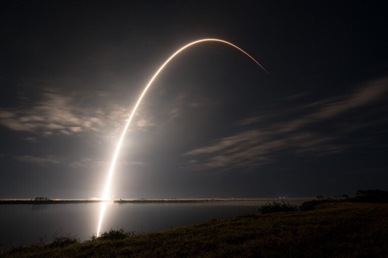 An undated photo shows a SpaceX Falcon 9 rocket carrying Starlink communications satellites into orbit. The Starlink constellation is made up of thousands of satellites that are difficult for adversaries to target.