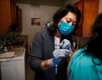 Dr. Jeanie Tse, chief medical officer at the Institute for Community Living, administers antipsychotic medication to a patient living with schizophrenia in her home