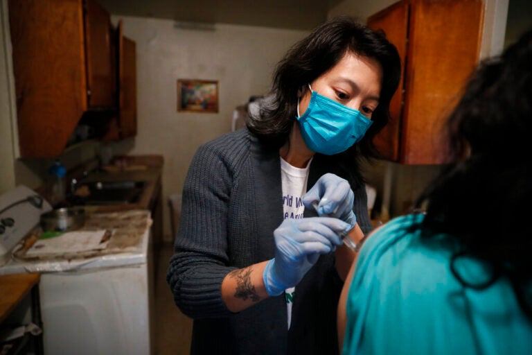 Dr. Jeanie Tse, chief medical officer at the Institute for Community Living, administers antipsychotic medication to a patient living with schizophrenia in her home