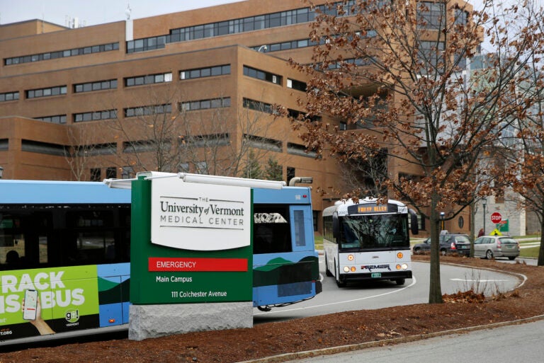Buses travel through the main campus of the University of Vermont Medical Center, Friday Nov. 20, 2020, in Burlington, Vt.