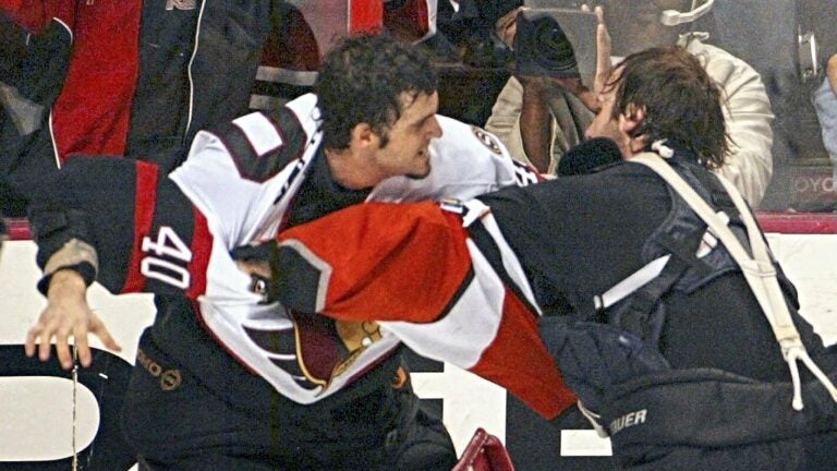 Ottawa Senators goalie Patrick Lalime (40) and Philadelphia Flyers goalie Robert Esche join in the fight-filled final 1:45 of the third period of an NHL hockey game March 5, 2004, in Philadelphia.