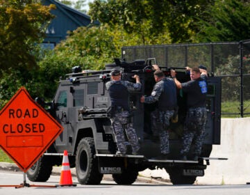 Law enforcement officers ride by a roadblock as the search for escaped convict Danilo Cavalcante continues in Pottstown, Pa., Tuesday, Sept. 12, 2023.