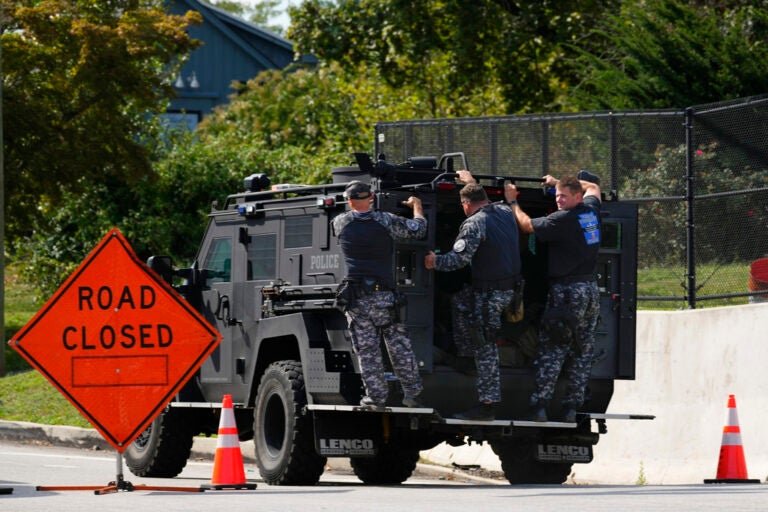 Law enforcement officers ride by a roadblock as the search for escaped convict Danilo Cavalcante continues in Pottstown, Pa., Tuesday, Sept. 12, 2023.