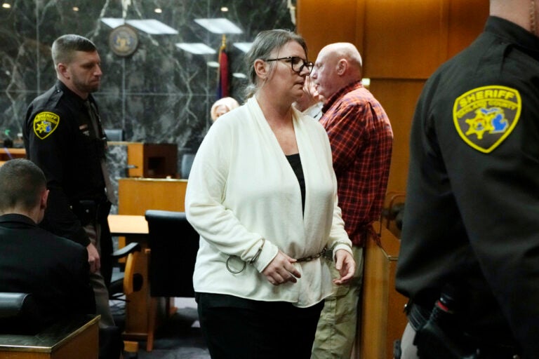 Jennifer Crumbley is escorted away, Monday, Feb. 5, 2024 in Pontiac, Mich. The jury received instructions from a judge and begin deliberations in an unusual trial against a school shooter's mother. (AP Photo/Carlos Osorio, Pool)