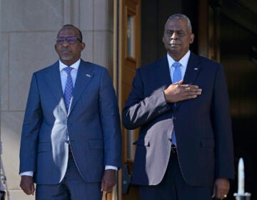 Defense Secretary Lloyd Austin (right) and Kenya's Defense Minister Aden Duale (left) listen during the National Anthem during a ceremony at the Pentagon in Washington, Wednesday, Feb. 7, 2024.