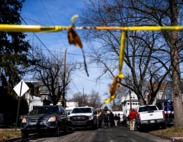 Investigators work at the scene of a shooting and house fire where six people are presumed dead in East Lansdowne, Pa., Thursday, Feb. 8, 2024. (AP Photo/Matt Rourke)