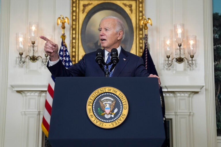 President Joe Biden speaks at the podium