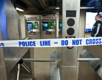 New York Police walk through the Mount Eden subway station while investigating a shooting, Monday, Feb. 12, 2024, in the Bronx borough of New York. Several people were shot Monday at the New York City subway station, police said.