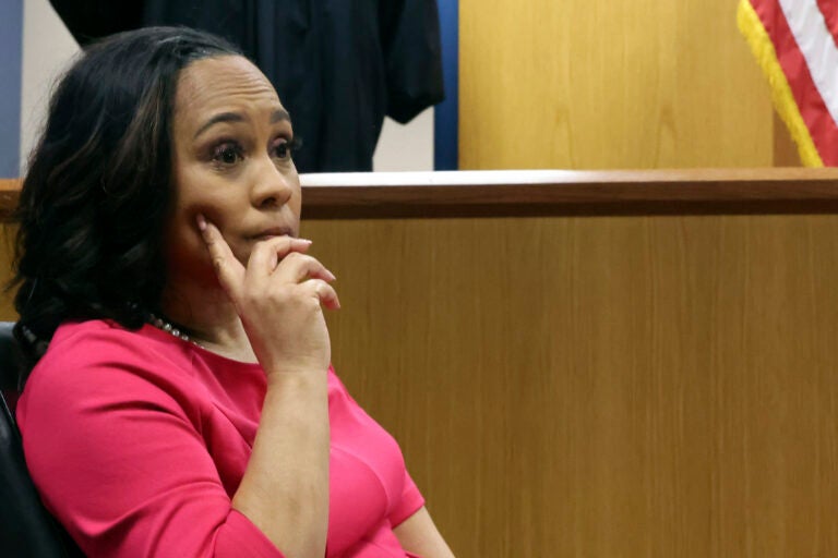 Fulton County District Attorney Fani Willis sits in the stand as Fulton County Superior Judge Scott McAfee steps away for a break during a hearing on the Georgia election interference case, Thursday, Feb. 15, 2024, in Atlanta. The hearing is to determine whether Willis should be removed from the case because of a relationship with Nathan Wade, special prosecutor she hired in the election interference case against former President Donald Trump. (Alyssa Pointer/Pool Photo via AP)