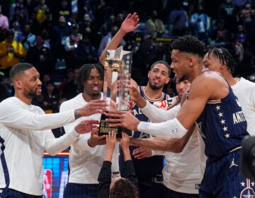 The East team, lead by captain Milwaukee Bucks forward Giannis Antetokounmpo (right) hoists the trophy after defeating the West 211-186 in the NBA All-Star basketball game in Indianapolis, Sunday, Feb. 18, 2024. (AP Photo/Darron Cummings)