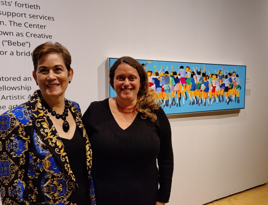 Co-curators Maida Milone and Genevieve Coutroubis in front of Zui Chen’s ''Up Up and Away'' (2023) at the Michener Museum.