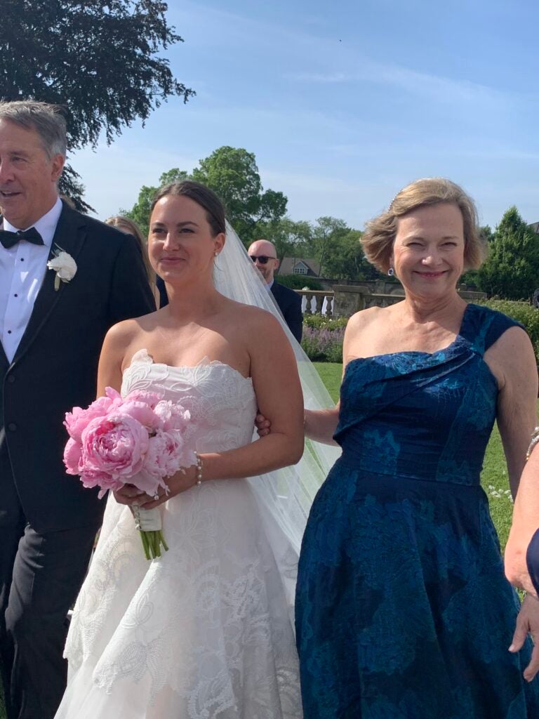 Nancy Oetinger walks one of her daughters down the aisle at her wedding.