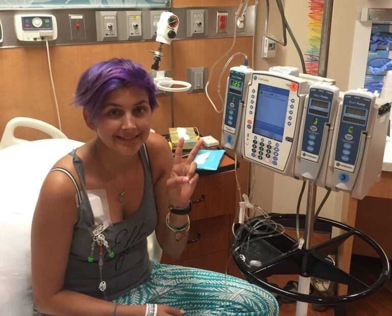 Blood cancer patient Elle Crofton poses for a picture in the hospital.