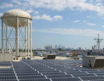 A solar array on a rooftop at Philadelphia's Navy Yard is visible on a sunny day