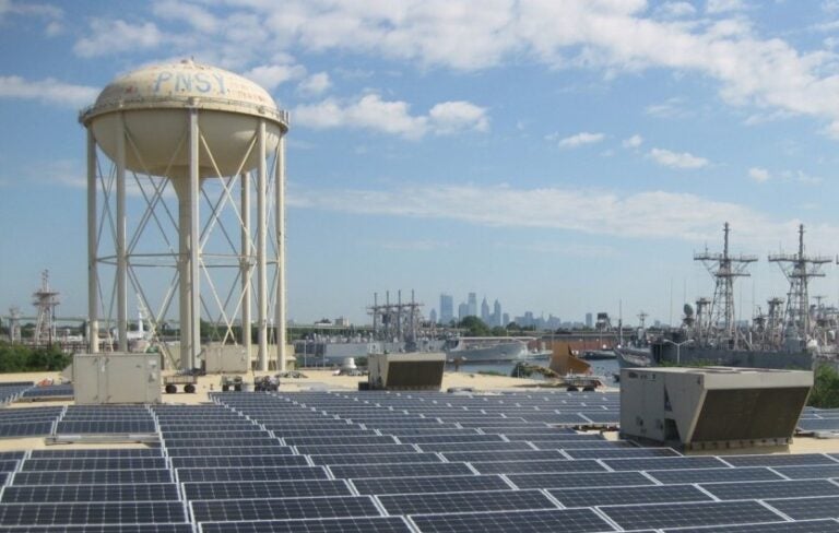 A solar array on a rooftop at Philadelphia's Navy Yard is visible on a sunny day