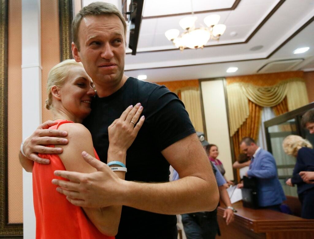 Russian opposition leader Alexei Navalny (right) embraces his wife Yulia, as he was released in a courtroom in Kirov, Russia, on July 19, 2013. Navalny died in prison on Friday