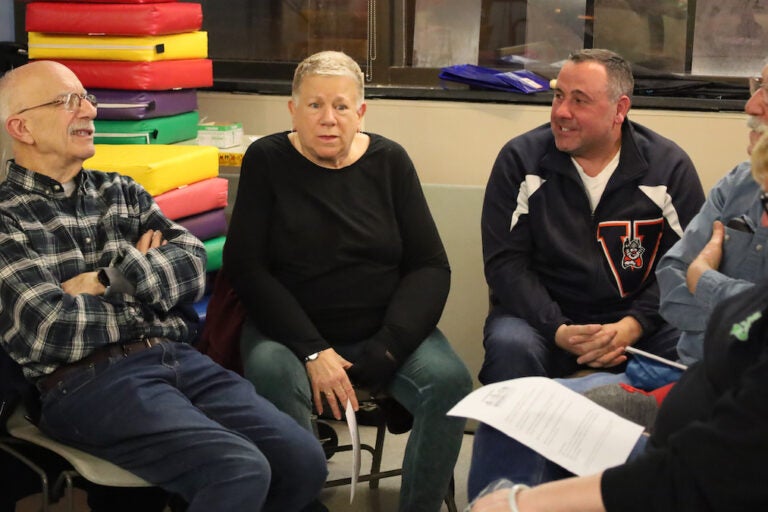 Community members talk together at a Bridging Blocks community discussion about the Mummers