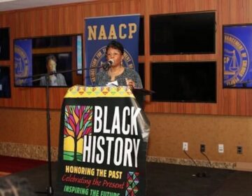 Karen Downer speaking at a podium