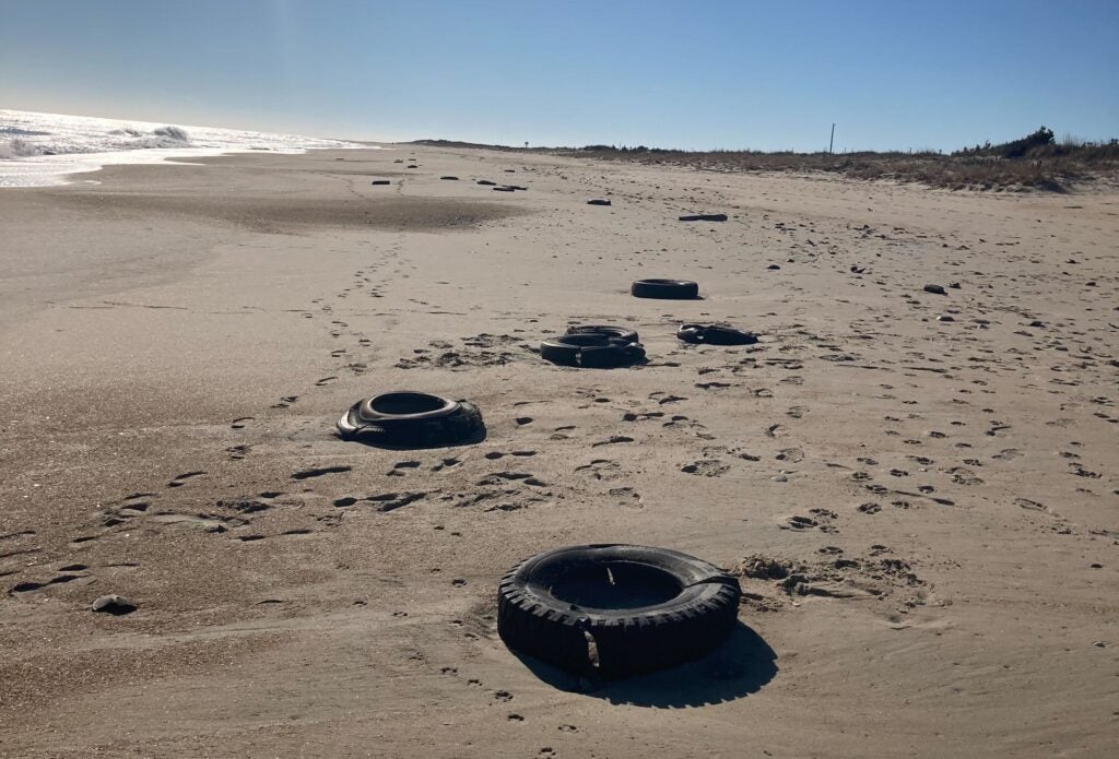 Tires strewn along the beach
