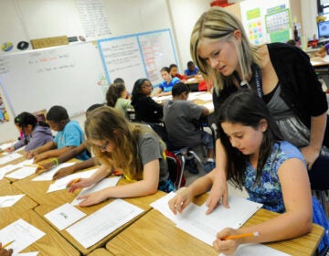 Amy Lawson, a fifth-grade teacher at Silver Lake Elementary School in Middletown, Del., helps student Melody Fritz with an English language arts lesson Oct. 1, 2013.