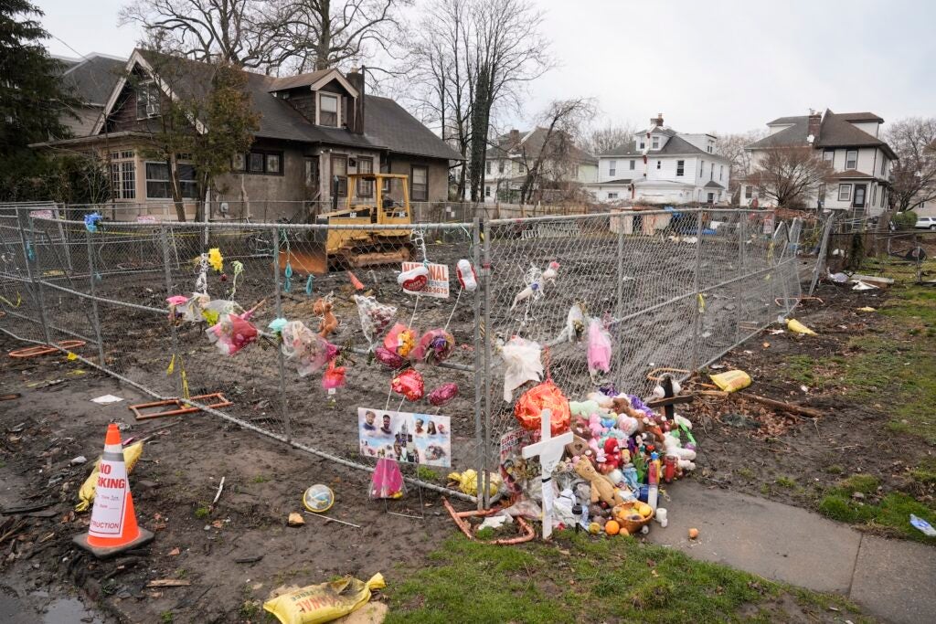 A makeshift memorial at the scene of a shooting and house fire that killed six members of an extended family in East Lansdowne