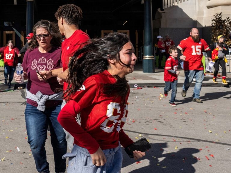 People flee after shots were fired near the Kansas City Chiefs' Super Bowl LVIII victory parade