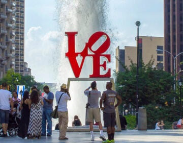 Tourists gather at the LOVE sculpture