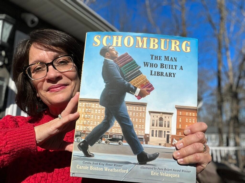 Meg Medina, the 2023 – 2024 National Ambassador of Young People's Literature and a children's author, holds her book choice for Black History Month.