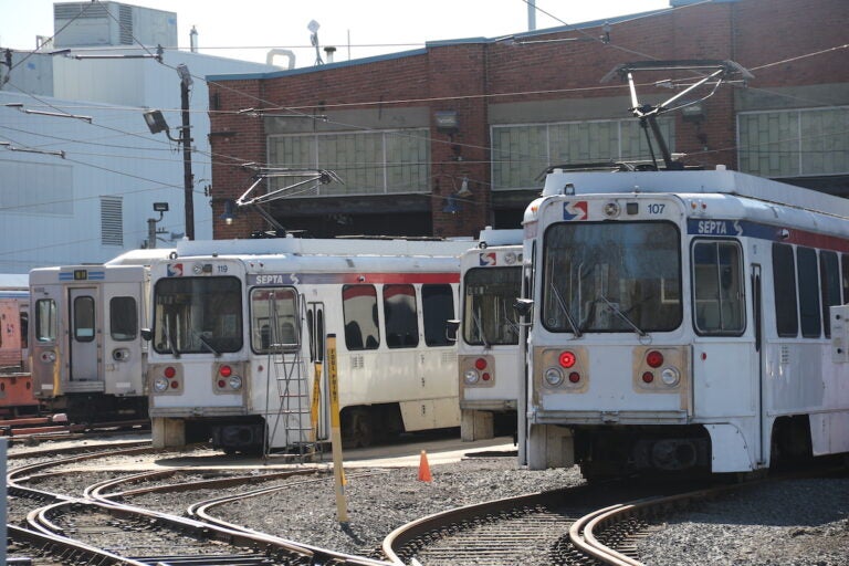 Trolleys and rail cars lined up next to each other at the 69th Street Transportation Center