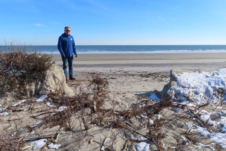 Mayor Patrick Rosenello stands next to a destroyed section of sand dune in North Wildwood