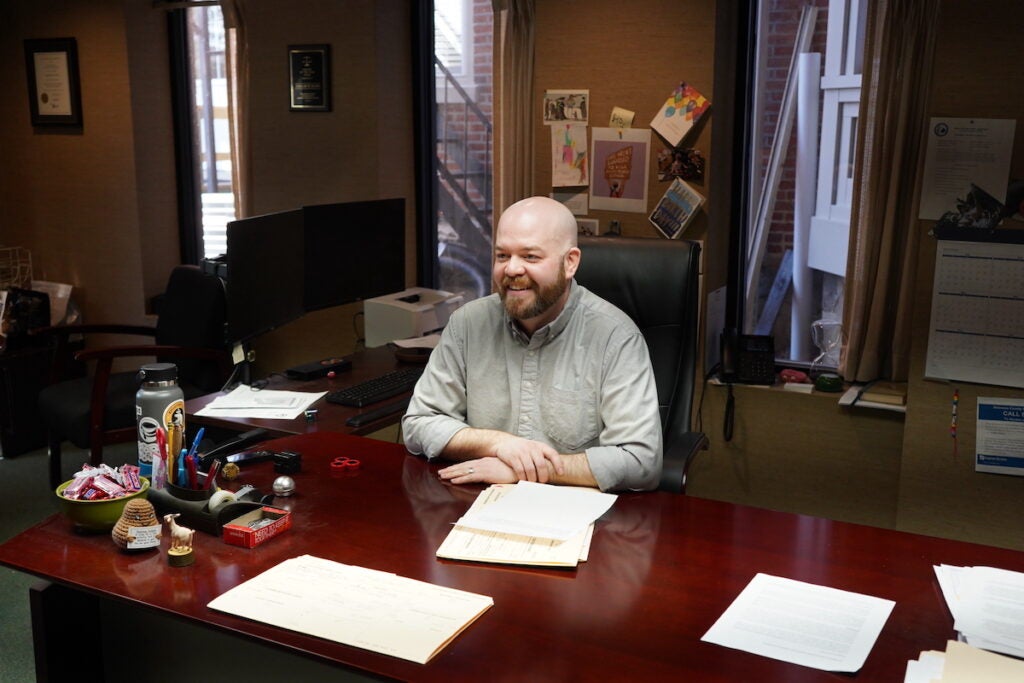 Taylor Dunn poses for a photo at a desk