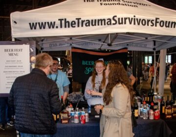 People standing together at a table at the Philly Beer Fest