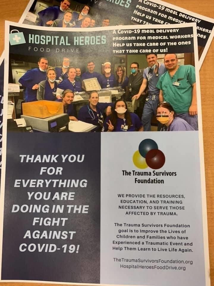 A sign shows hospital workers and reads, "Thank you for everything you are doing in the fight against COVID-19"