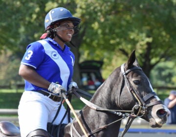 Shariah Harris smiles while riding her horse