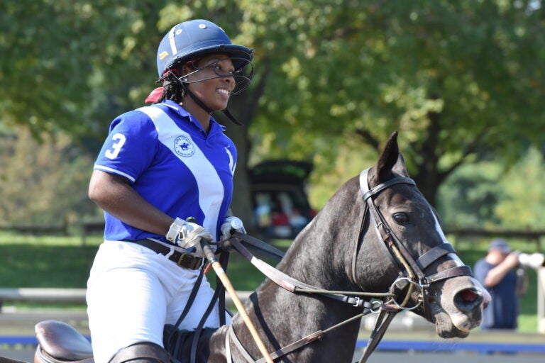 Shariah Harris smiles while riding her horse