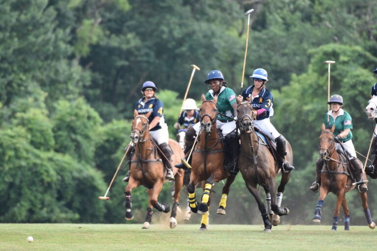 Shariah Harris playing polo with other competitors.
