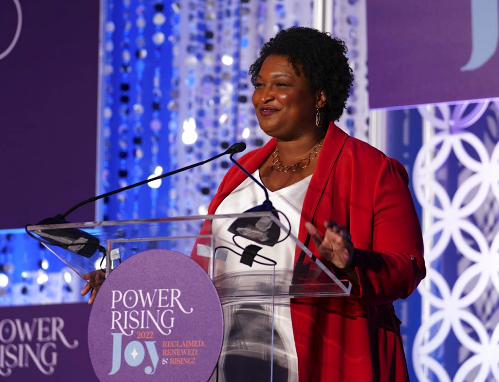 Stacey Abrams speaking at a podium