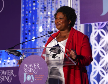 Stacey Abrams speaking at a podium