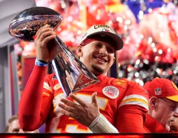 Kansas City Chiefs quarterback Patrick Mahomes celebrates with the trophy after the team's win in overtime during the NFL Super Bowl 58 football game against the San Francisco 49ers on Sunday, Feb. 11, 2024, in Las Vegas. The Chiefs won 25-22.